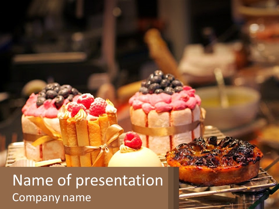 A Table Topped With Cakes And Pastries Covered In Icing PowerPoint Template