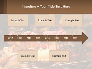A Table Topped With Cakes And Pastries Covered In Icing PowerPoint Template