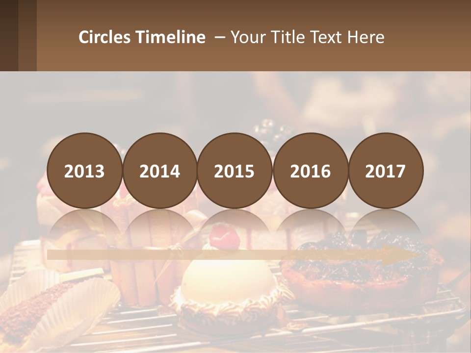 A Table Topped With Cakes And Pastries Covered In Icing PowerPoint Template