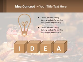 A Table Topped With Cakes And Pastries Covered In Icing PowerPoint Template