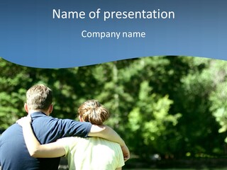 A Man And A Woman Hugging In A Park PowerPoint Template