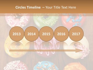 A Group Of Donuts Sitting On Top Of A Wooden Table PowerPoint Template
