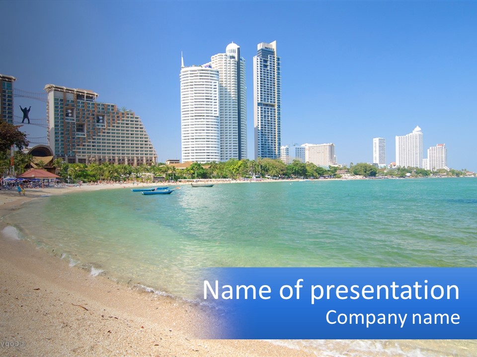 A Beach With A Boat In The Water And A City In The Background PowerPoint Template