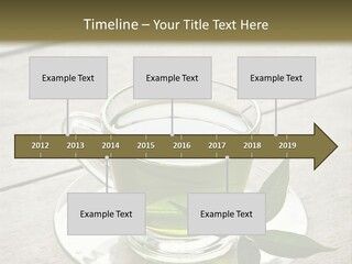 A Cup Of Green Tea With A Leaf On A Saucer PowerPoint Template