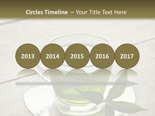 A Cup Of Green Tea With A Leaf On A Saucer PowerPoint Template