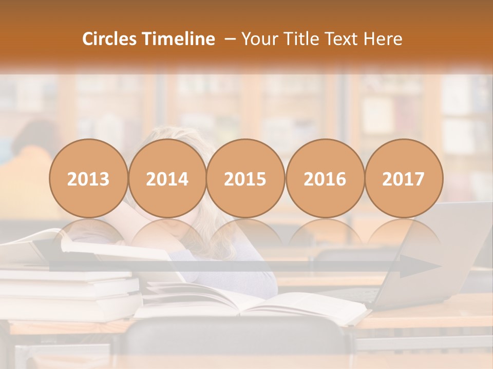 A Woman Sitting At A Desk With A Laptop Computer PowerPoint Template