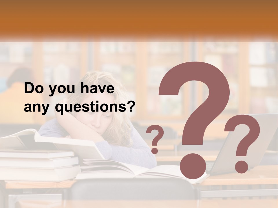 A Woman Sitting At A Desk With A Laptop Computer PowerPoint Template