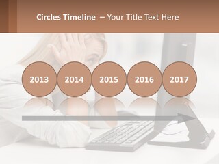 A Woman Sitting In Front Of A Computer With Her Hands On Her Head PowerPoint Template