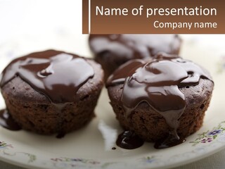 Three Chocolate Muffins On A Plate With Chocolate Drizzled On Them PowerPoint Template