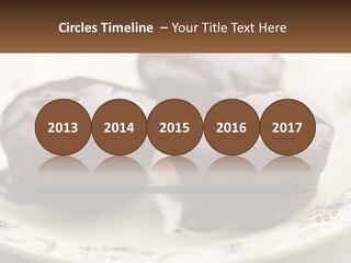 Three Chocolate Muffins On A Plate With Chocolate Drizzled On Them PowerPoint Template