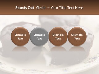 Three Chocolate Muffins On A Plate With Chocolate Drizzled On Them PowerPoint Template