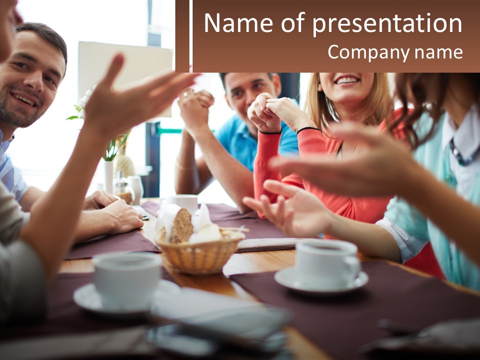 A Group Of People Sitting Around A Wooden Table PowerPoint Template