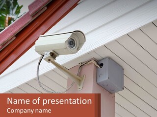 A Security Camera Attached To The Side Of A House PowerPoint Template