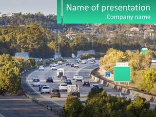 A Highway Filled With Lots Of Traffic Next To Trees PowerPoint Template