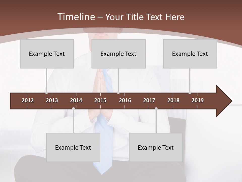 A Man Sitting On A Desk With His Hands Folded In Front Of Him PowerPoint Template