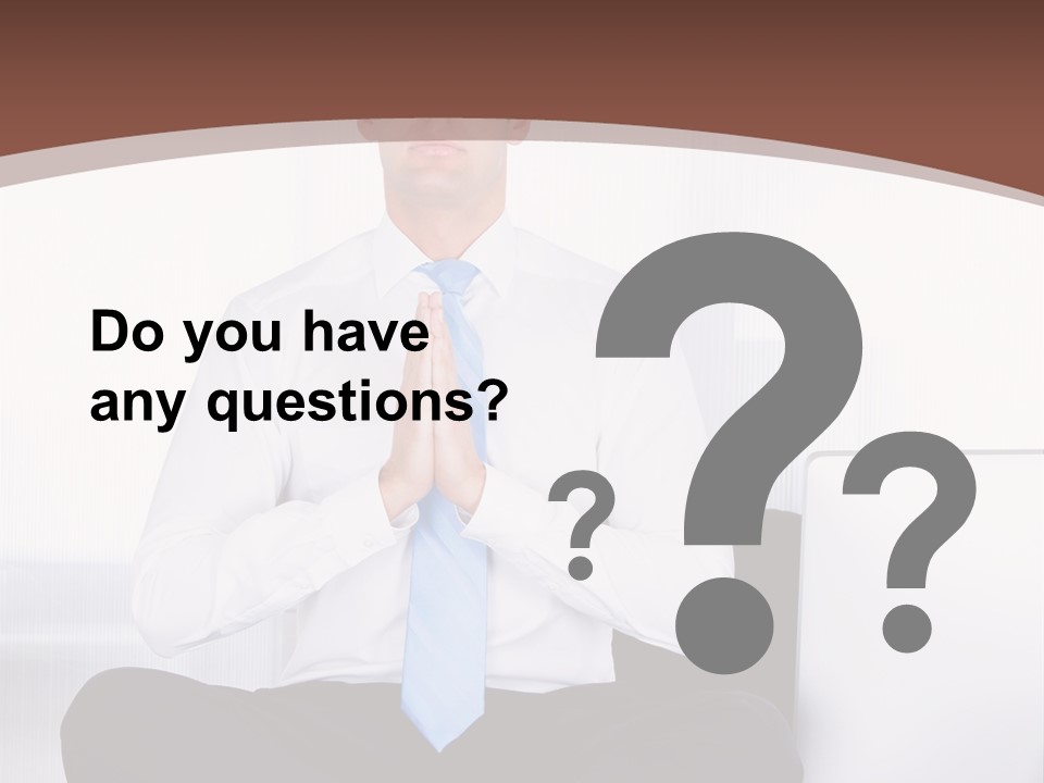 A Man Sitting On A Desk With His Hands Folded In Front Of Him PowerPoint Template