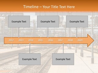 A Train Station With A Train On The Tracks PowerPoint Template