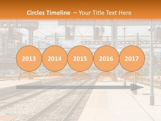A Train Station With A Train On The Tracks PowerPoint Template