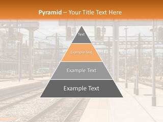 A Train Station With A Train On The Tracks PowerPoint Template