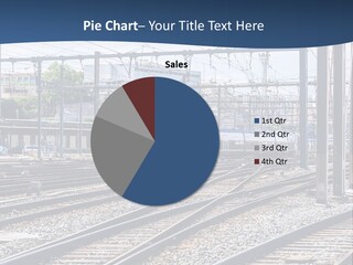 A Blue And White Train Traveling Down Train Tracks PowerPoint Template