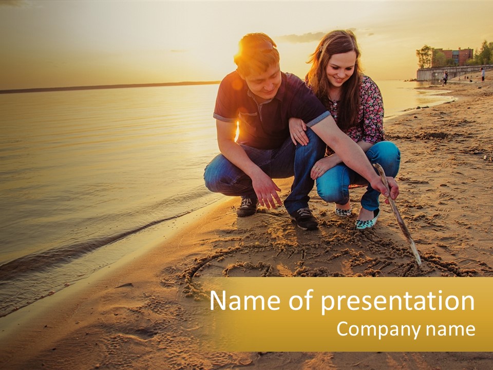 A Man And Woman Kneeling Down On The Beach PowerPoint Template