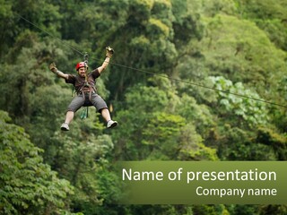 A Man Is Zipping Through The Air On A Rope PowerPoint Template