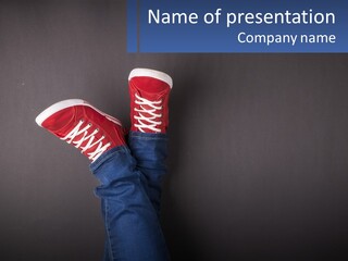 A Person's Feet With Red Sneakers On A Gray Background PowerPoint Template