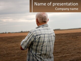 A Man Standing In A Field Looking At The Sky PowerPoint Template
