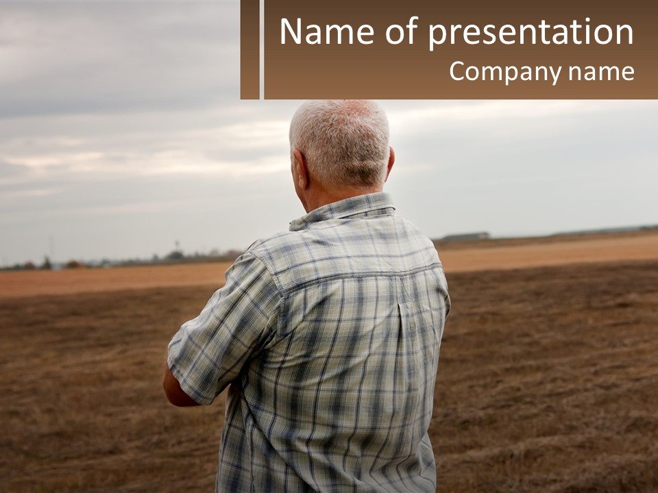 A Man Standing In A Field Looking At The Sky PowerPoint Template