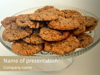 A Glass Plate Filled With Cookies On Top Of A Table PowerPoint Template