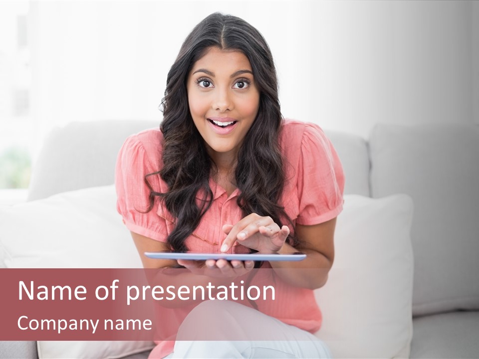 A Woman Sitting On A Couch Holding A Tablet PowerPoint Template