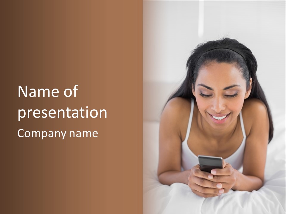 A Woman Laying In Bed Looking At Her Cell Phone PowerPoint Template