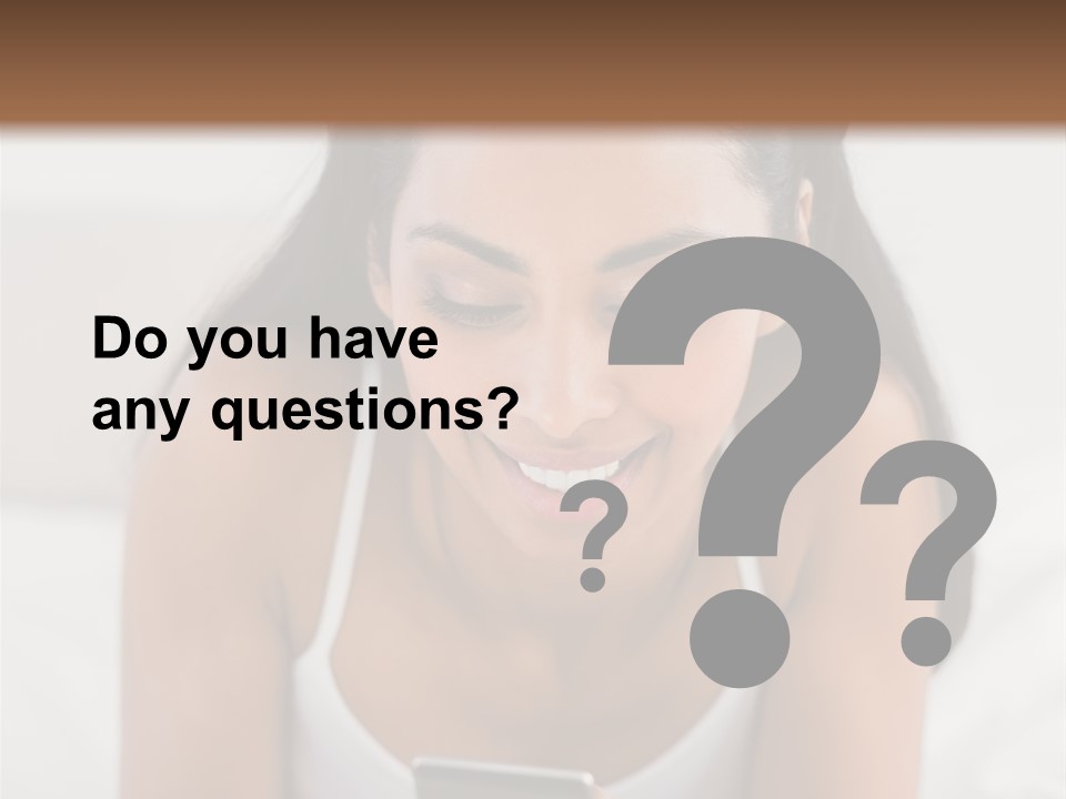 A Woman Laying In Bed Looking At Her Cell Phone PowerPoint Template