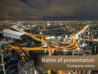 An Aerial View Of A City At Night PowerPoint Template