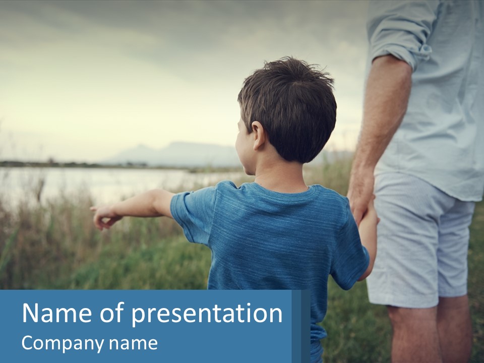 A Young Boy Holding The Hand Of An Adult PowerPoint Template