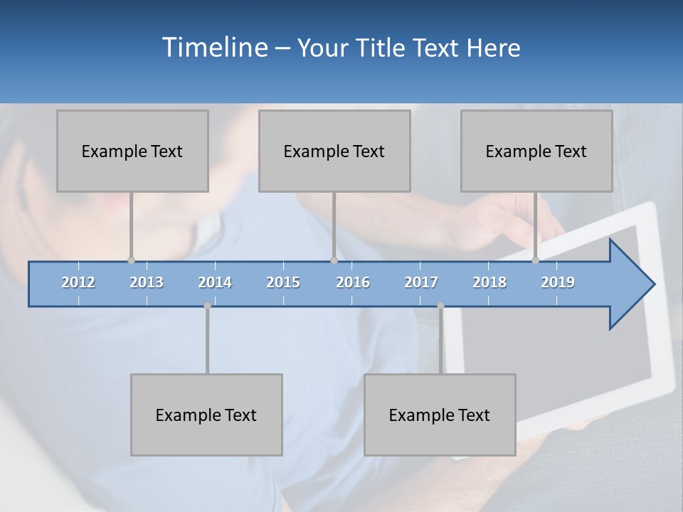 A Man Sitting On A Couch Holding A Tablet PowerPoint Template
