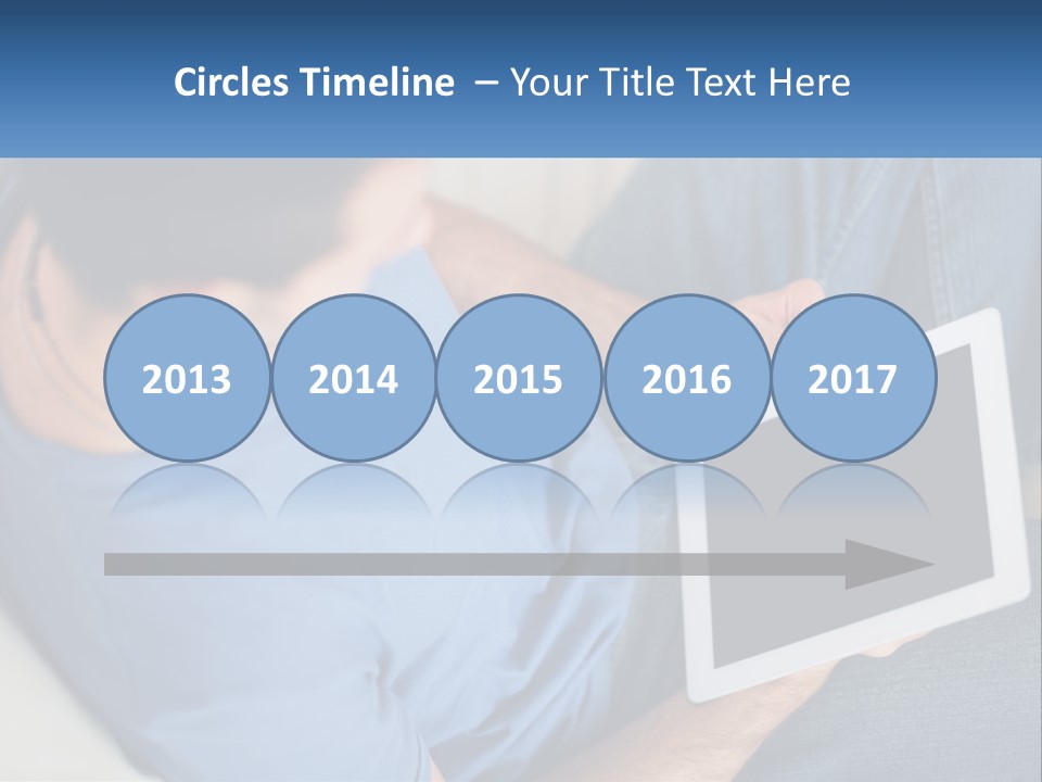 A Man Sitting On A Couch Holding A Tablet PowerPoint Template