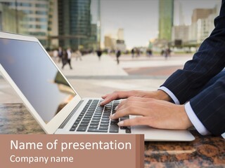A Person Typing On A Laptop On A Table PowerPoint Template
