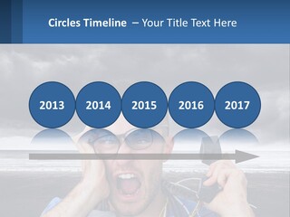 A Man Holding A Cell Phone Up To His Face PowerPoint Template