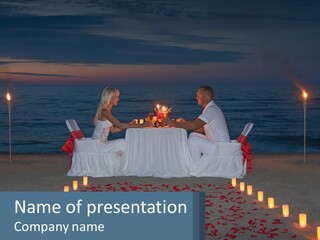 A Man And Woman Sitting At A Table On The Beach PowerPoint Template