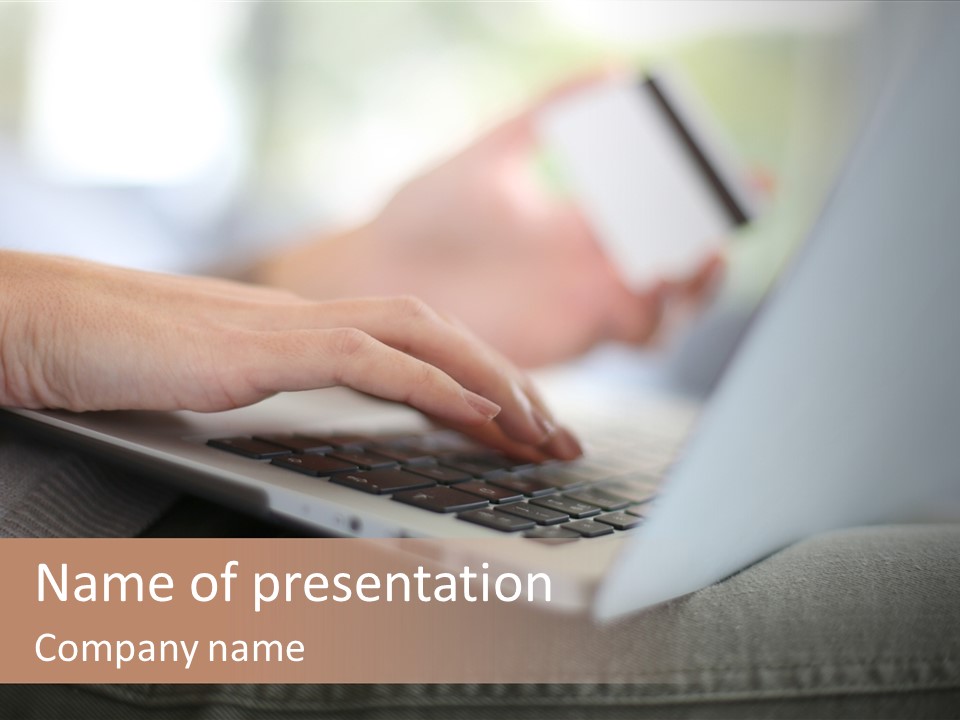 A Person Using A Laptop With A Credit Card In Their Hand PowerPoint Template