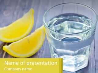 A Glass Of Water With Lemons On A Wooden Table PowerPoint Template