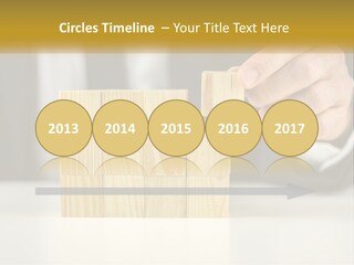 A Business Man Stacking Wooden Blocks On Top Of A Table PowerPoint Template