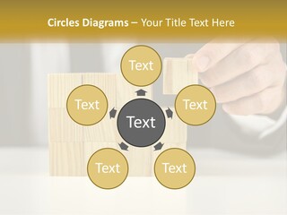 A Business Man Stacking Wooden Blocks On Top Of A Table PowerPoint Template