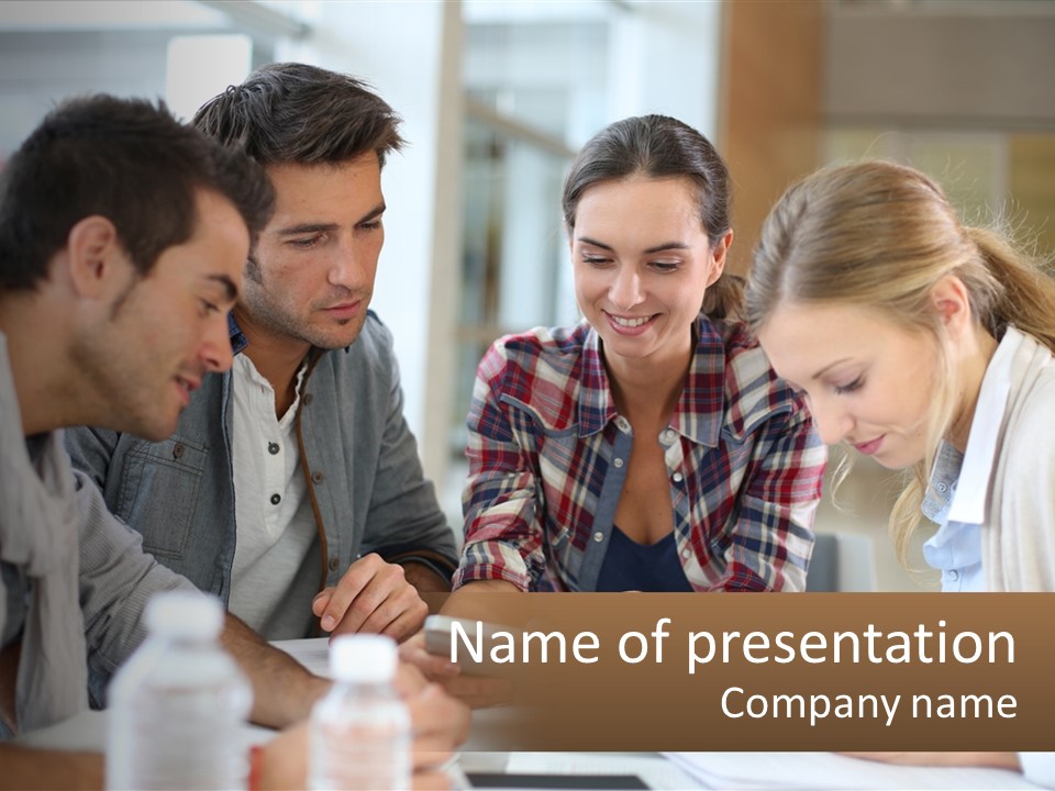 A Group Of People Looking At Something On A Table PowerPoint Template