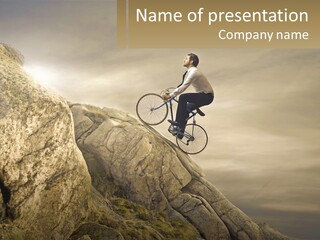 A Man Riding A Bike On Top Of A Mountain PowerPoint Template