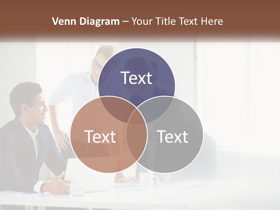 A Group Of People Sitting Around A Table With A Laptop PowerPoint Template