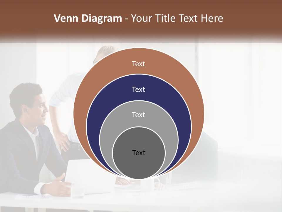 A Group Of People Sitting Around A Table With A Laptop PowerPoint Template