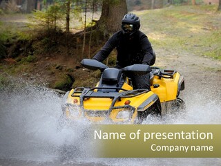 A Man Riding A Yellow Four - Wheeler Through Water PowerPoint Template