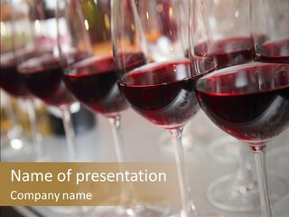 A Row Of Wine Glasses Filled With Red Wine PowerPoint Template